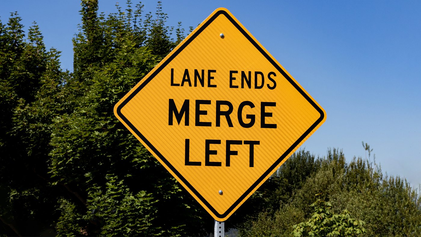 Road Sign that says "Lane Ends Merge Left"